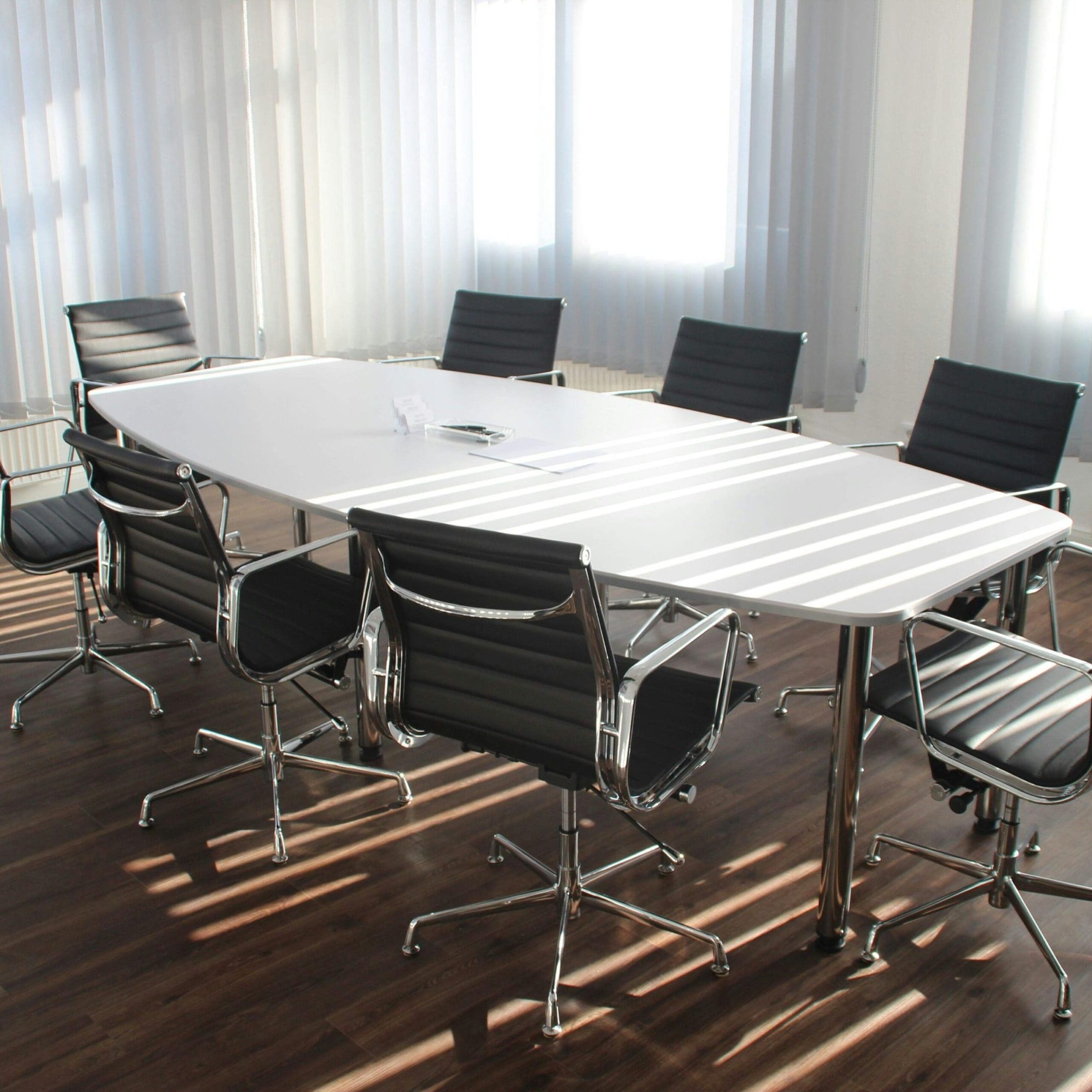 A conference table with six chairs around it.